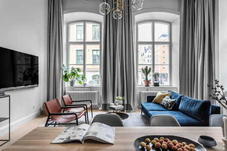 Contemporary living room with arched windows and elegant decor.