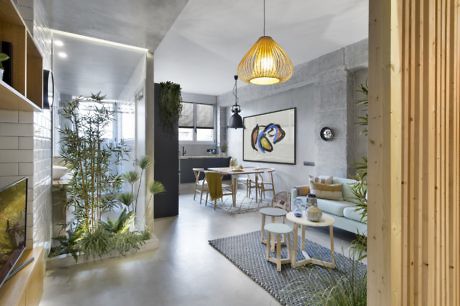 Contemporary open-plan living space with concrete walls and wooden accents.