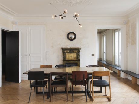 Minimalist dining room with a mix of chairs, a vintage fireplace, and a