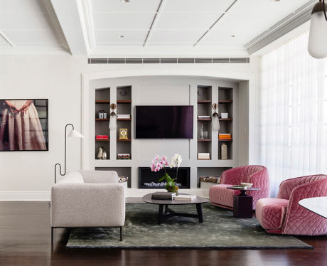 Contemporary living space with built-in shelving and chic furniture.