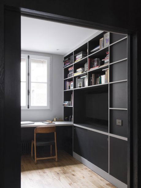 Contemporary study with built-in shelving and a wooden desk.