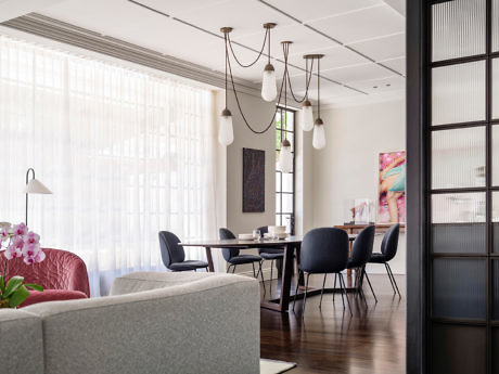 Chic dining room with elegant pendant lighting and dark chairs.