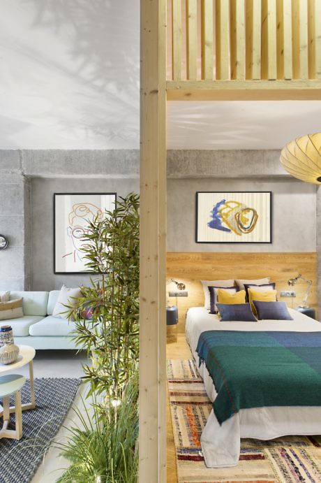 Contemporary loft bedroom with a wooden mezzanine and textured decor.
