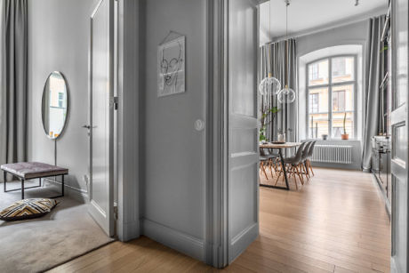 Elegant interior with high ceilings, large windows, and chic decor.