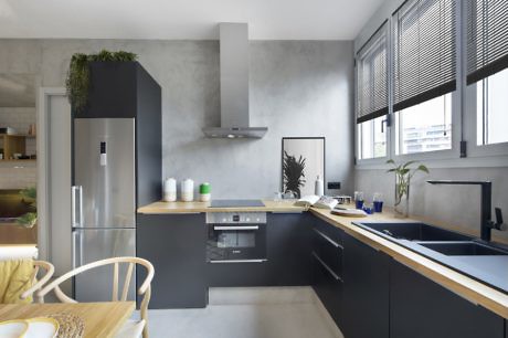 Modern kitchen with stainless steel appliances and gray cabinets.