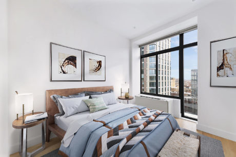 Modern bedroom with large window, bed, and wall art.