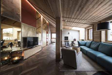 Modern living room with wooden finishes and blue sofa.