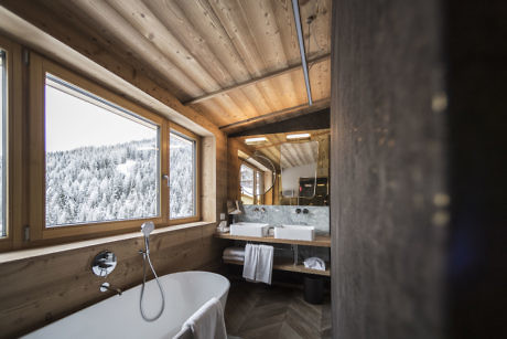 Contemporary wooden cabin interior with snowy forest view.