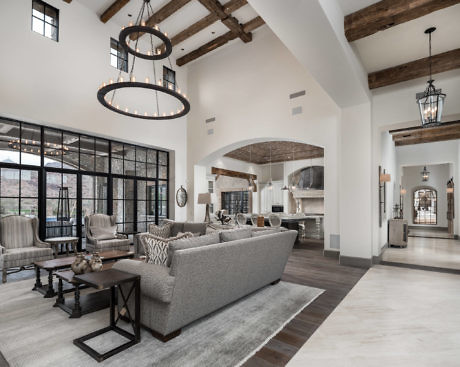 Elegant open-plan living space with high ceilings and exposed beams.