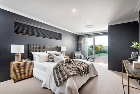 Modern bedroom with a large bed, dark walls, and sliding door leading outside.