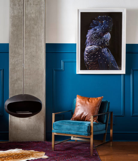 Elegant room with blue wainscoting, hanging chair, and teal accent