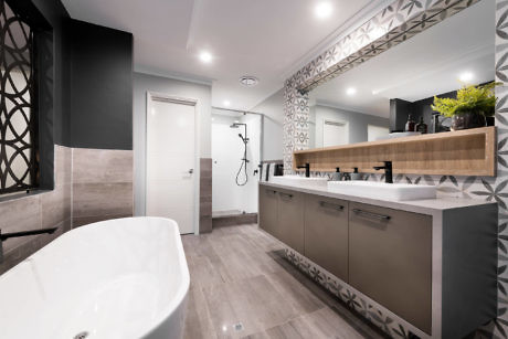Modern bathroom interior with a freestanding tub and double vanity.