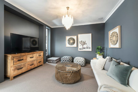 Elegant living room with dark walls, chic decor, and a classy chandelier