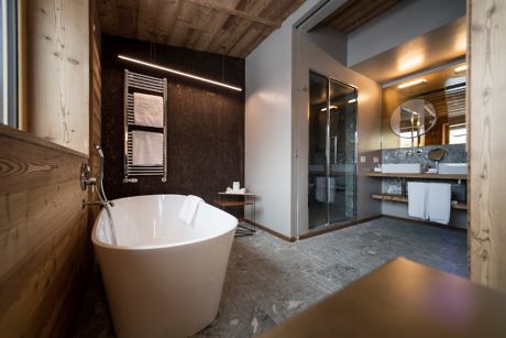 Contemporary bathroom with standalone tub and glass shower.