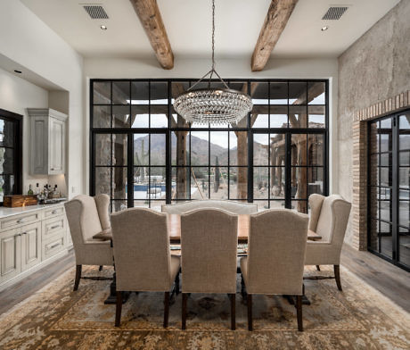 Elegant dining room with large chandelier and floor-to-ceiling windows.
