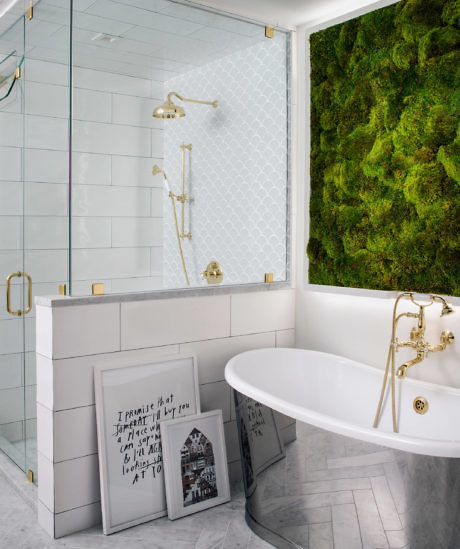 Elegant bathroom with a white freestanding tub, gold fixtures, and a
