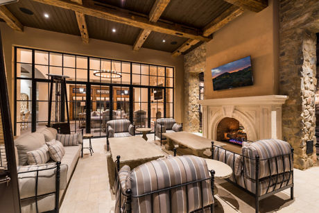 Elegant living room with stone fireplace and exposed beams.