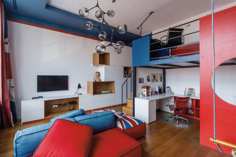 Modern living room with blue and red decor and a loft bed.