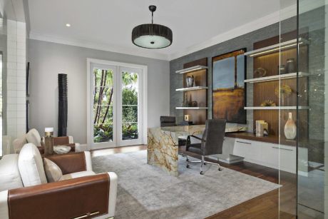 Contemporary home office with glass partition and wooden accents.