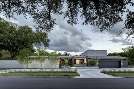 Contemporary house with flat roofs, large windows, and a neutral color palette.