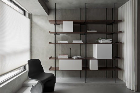 Contemporary room with minimalist shelving and a sculptural black chair.
