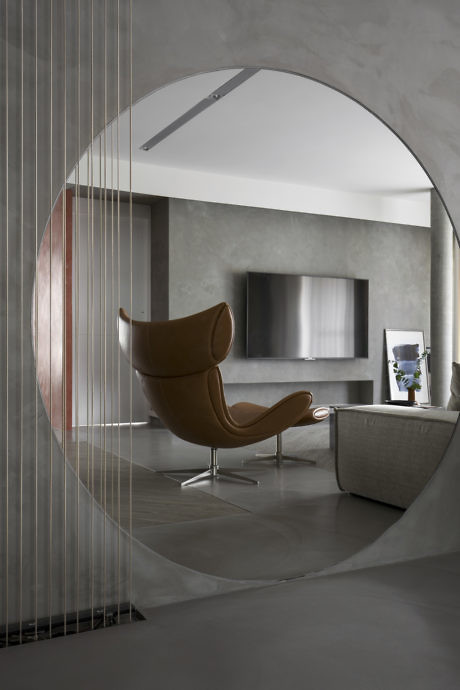 Contemporary room with an arched entryway, designer chair, and sleek decor