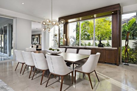 Contemporary dining room with sleek furniture and large windows.
