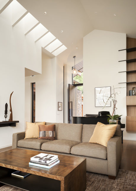 Contemporary living room with skylights and neutral tones.