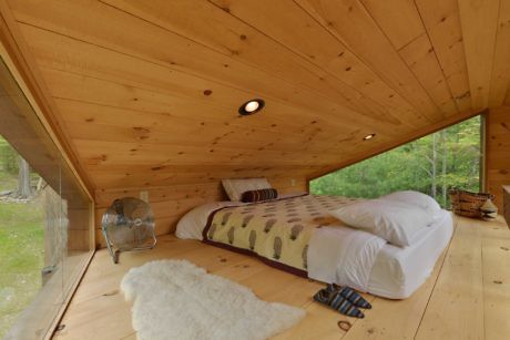 Contemporary wooden attic bedroom with large windows