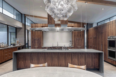 Modern kitchen interior with wood cabinets and large bubble chandelier.