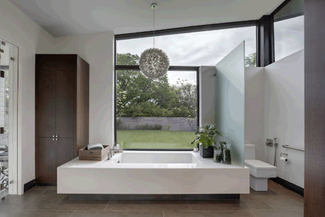 Sleek bathroom with large window and garden view.