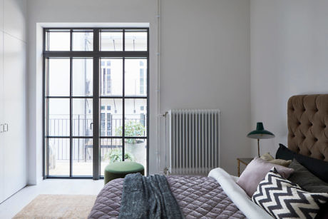 Contemporary living room with large windows and minimalist decor.