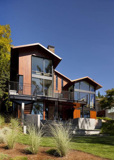 Contemporary house with wood siding and large windows.