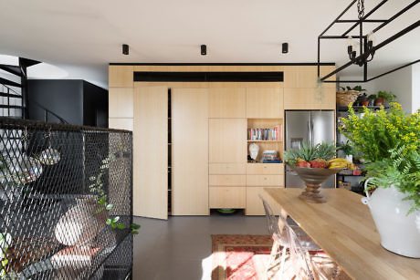 Contemporary kitchen with light wood cabinetry and open shelving, featuring a hanging
