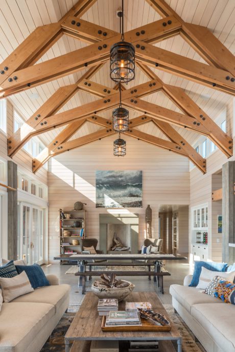 Vaulted ceiling with exposed beams in a bright, airy living space with chic decor