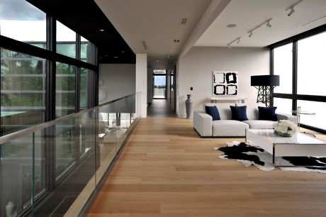 Sleek interior with large windows, open-plan living area, and hardwood floors