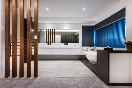 Modern kitchen with wooden slats, white cabinets, and a blue accent wall.