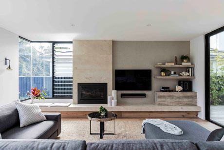 Modern living room with fireplace, TV, and minimalist decor.