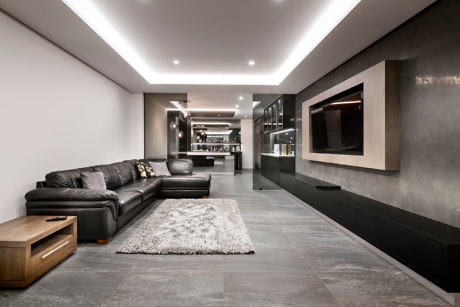Contemporary living room with sleek furniture and ambient lighting.