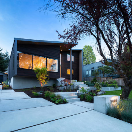 Contemporary house with angular design and warm lighting.