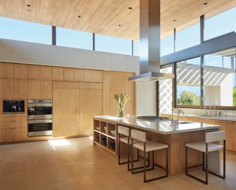 Sleek kitchen with wood finishes and abundant natural light.