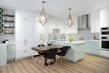 Modern kitchen interior with white cabinets, island, and pendant lights.