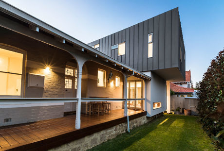 Contemporary home extension with contrasting traditional and sleek design elements.