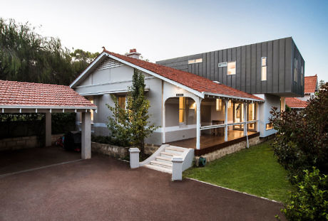 A hybrid home with traditional lower level and modern upper extension.