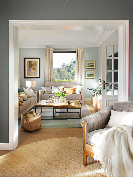 Elegant living room with neutral tones, plush sofa, and large window.