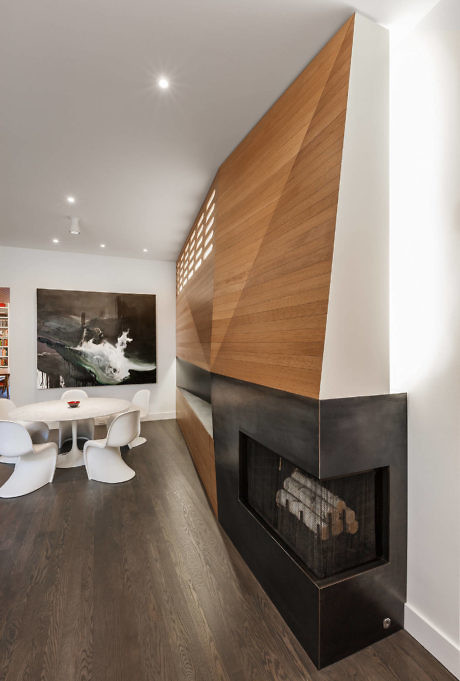Contemporary room with a sleek fireplace and wooden wall design.