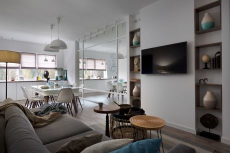 Open-plan living space with neutral colors and minimalist decor.