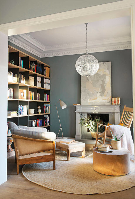 Cozy reading nook with chic pendant light and bookshelf.