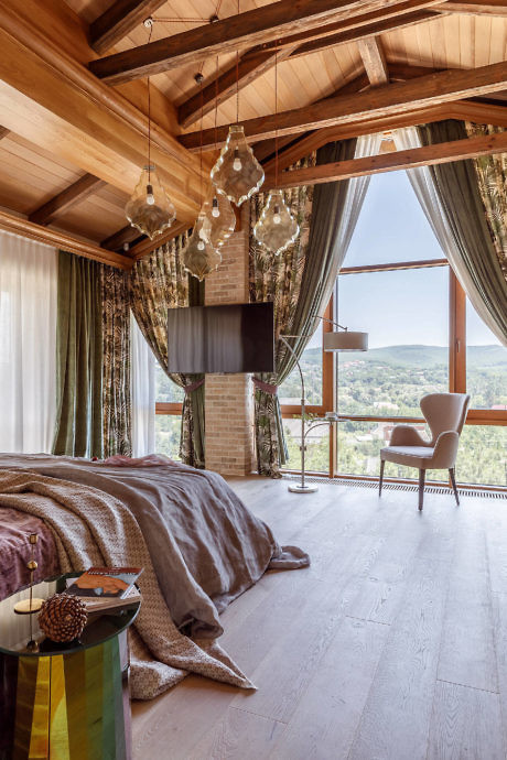 Wooden interior with exposed beams, floor-to-ceiling windows, and elegant ch