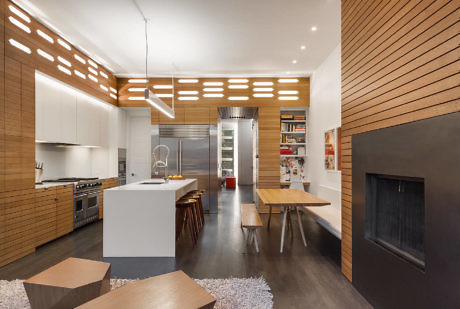 Modern kitchen with wooden details and integrated lighting.
